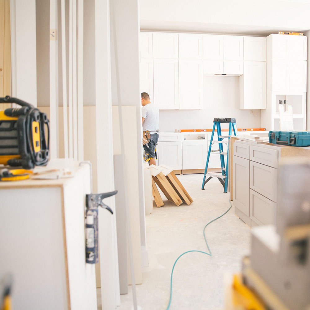 worker building a new white kitchen