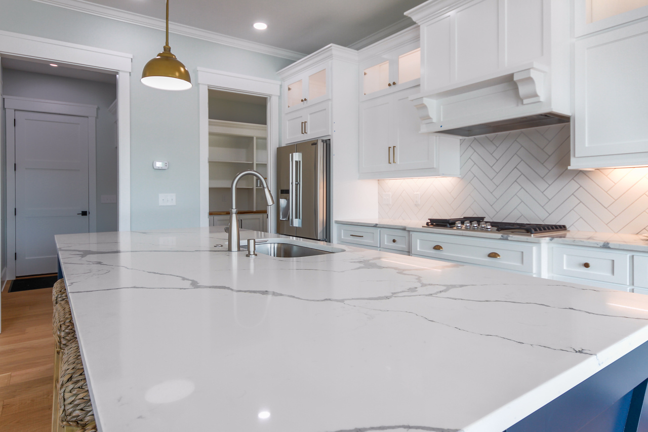 Caba Homes Gallery - white kitchen with blue island